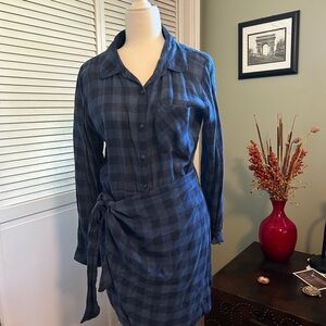 Very cute blue checked shirt with apron in front.